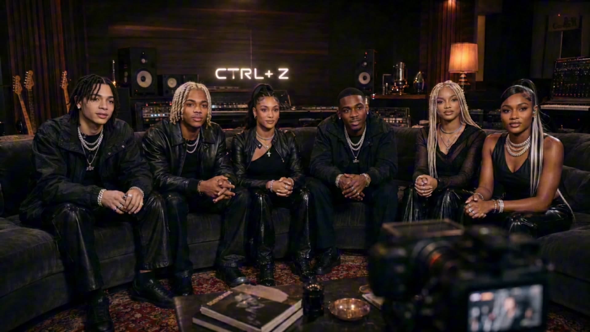 CTRL+Z — the six members seated together in the studio lounge
